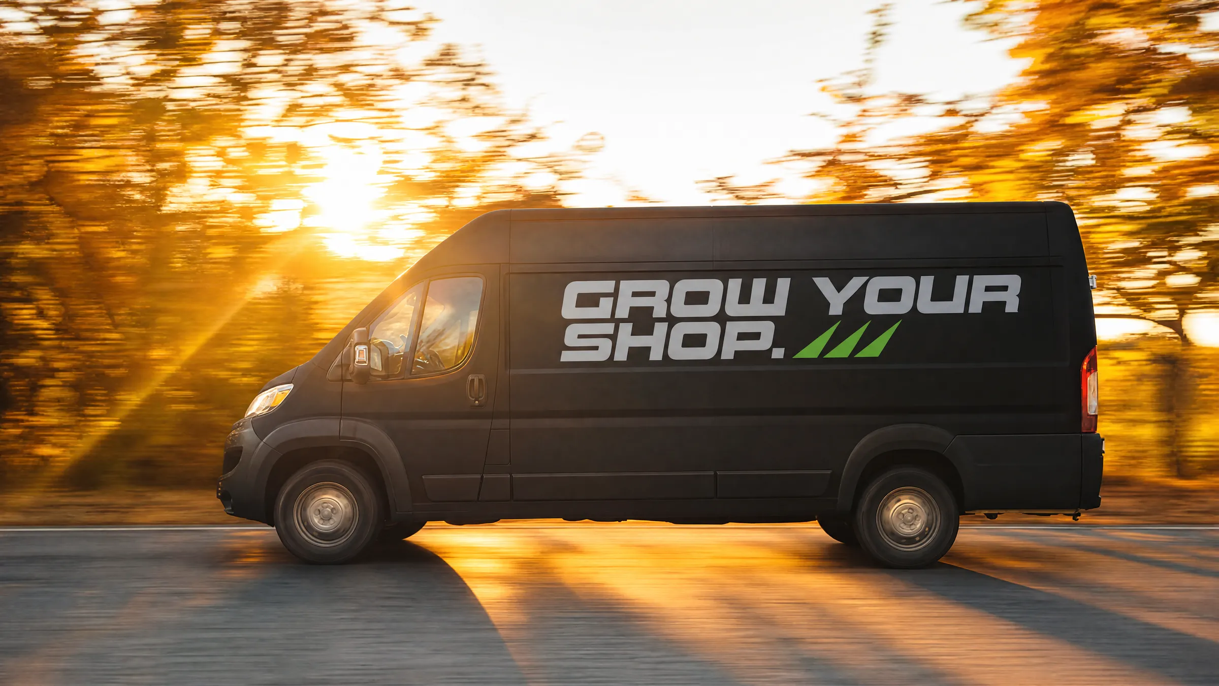 A matte black wrap-shop van reading GROW YOUR SHOP driving at golden hour